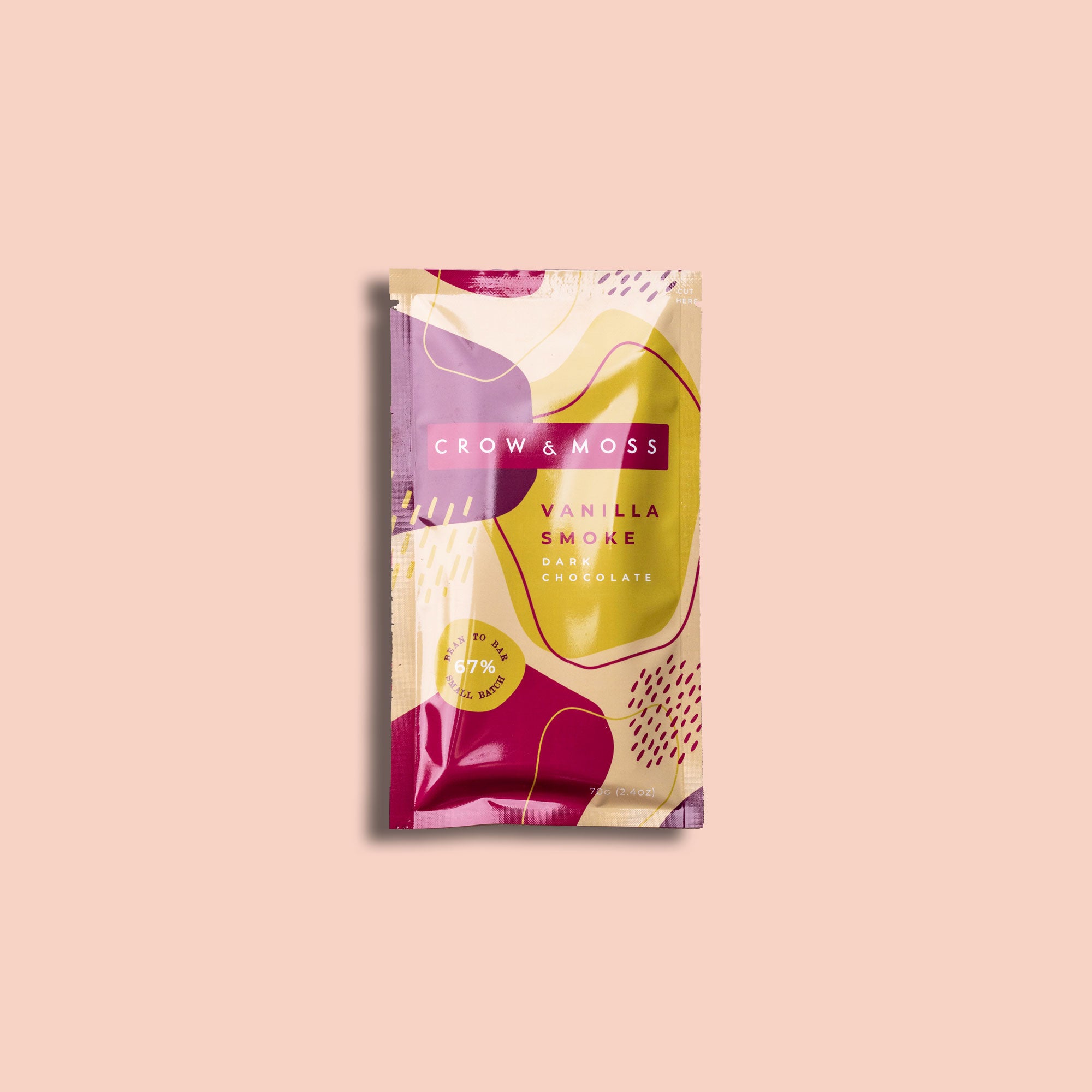 Image of the front of the packaging of our Vanilla Smoke Dark Chocolate Bar 69% on a light pink background.