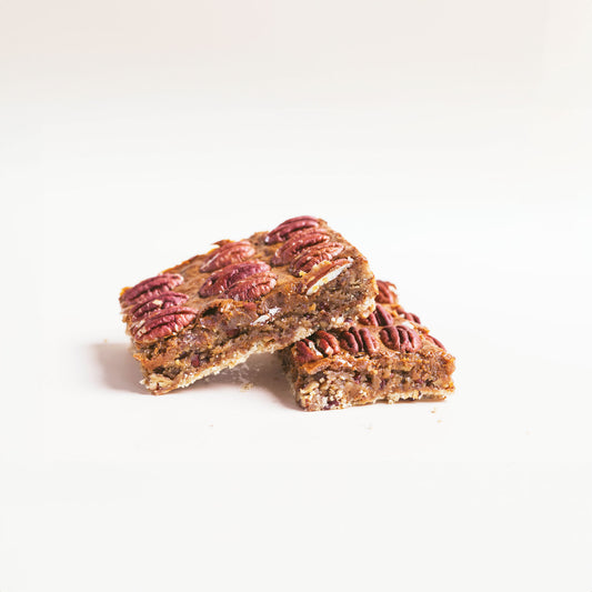 2 Pecan Pie Blondie Bars on a white background.